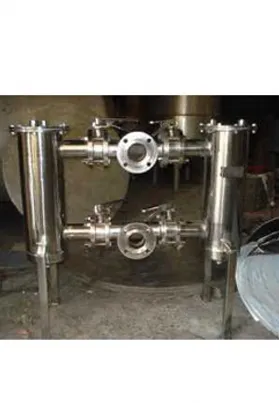Stainless steel duplex filters with dual cylindrical housings and flanged pipe connections for continuous filtration in industrial fluid systems