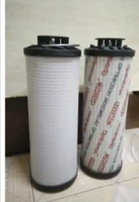 Two cylindrical replacement filters with black end caps, one featuring a plain white surface and the other printed with a branded pattern for identification